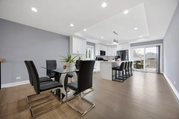 a kitchen with a sink stainless steel appliances and white cabinets