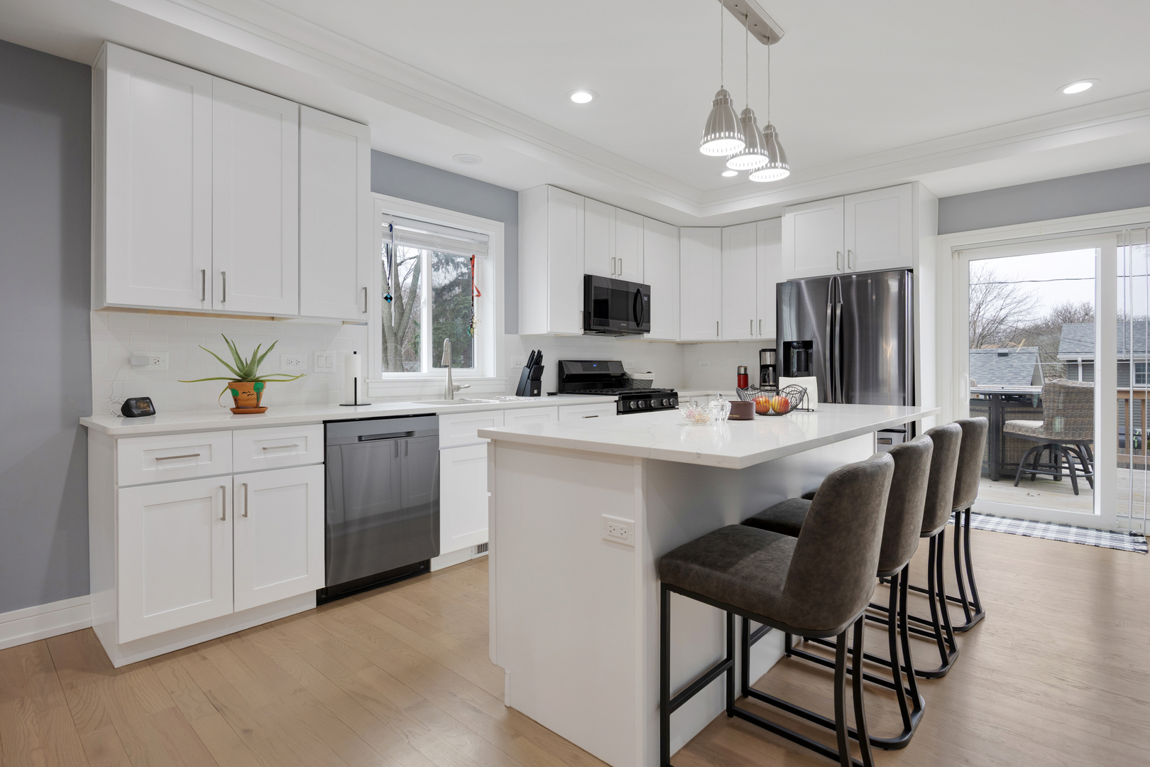 N112 Leonard Street Winfield, IL 60190 - Photo 10 of 26 a kitchen with a sink stainless steel appliances and white cabinets