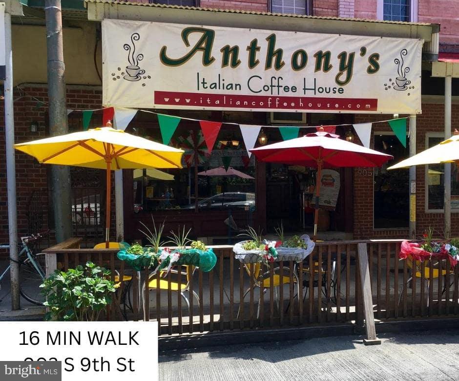 1214 Waverly Street, Unit 303 Philadelphia, PA 19147 - Photo 15 of 15 a view of a cafe with a table and chairs under an umbrella