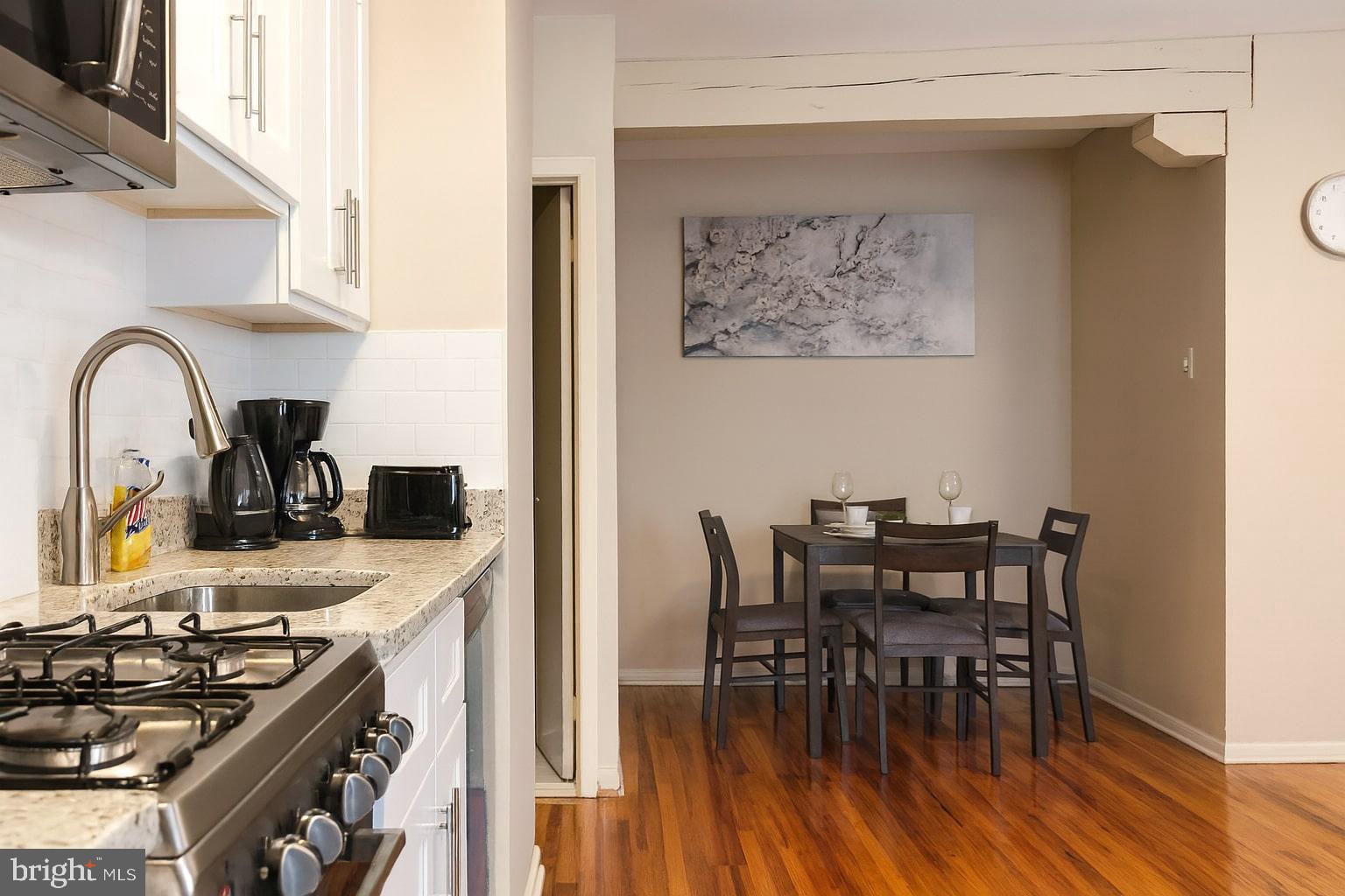 1214 Waverly Street, Unit 303 Philadelphia, PA 19147 - Photo 3 of 15 a kitchen with a table and chairs in it