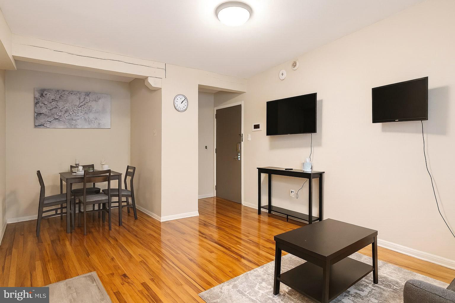 1214 Waverly Street, Unit 303 Philadelphia, PA 19147 - Photo 4 of 15 a living room with furniture and a flat screen tv