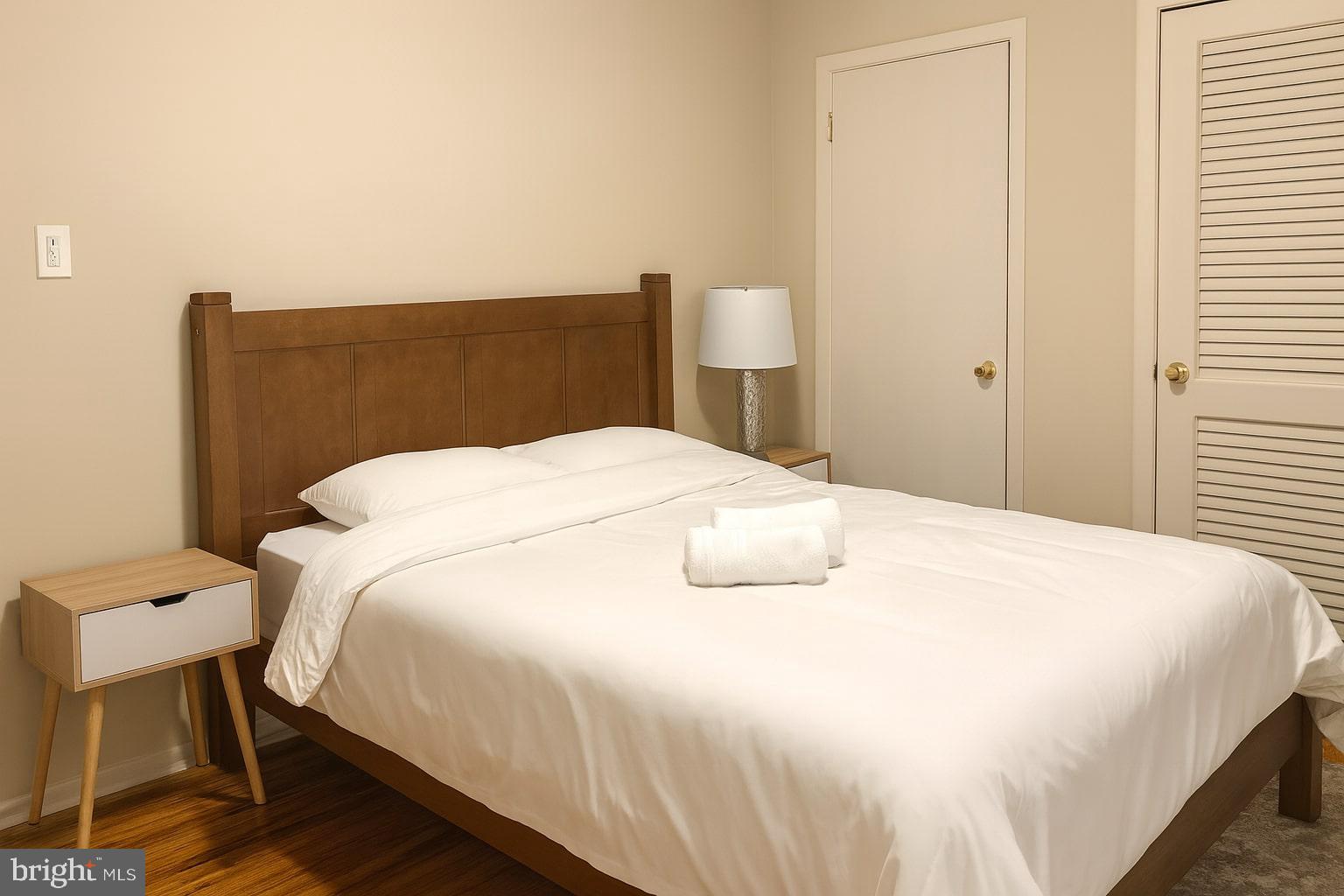 1214 Waverly Street, Unit 303 Philadelphia, PA 19147 - Photo 7 of 15 a large bed sitting in a bedroom next to a window and chair