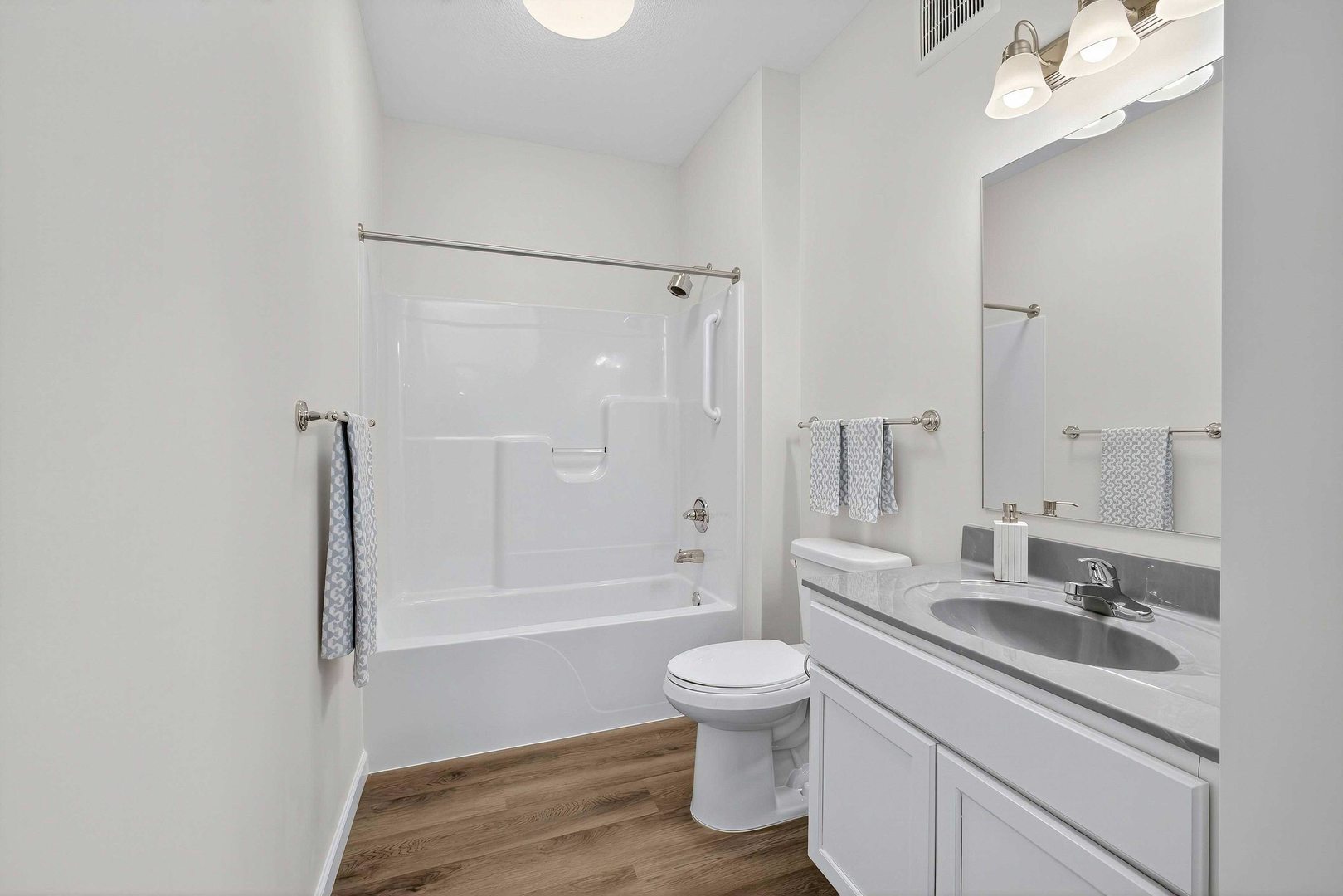 2592 Middle Road, Unit 202 Bettendorf, IA 52722 - Photo 21 of 50 a bathroom with a sink a toilet a mirror and shower