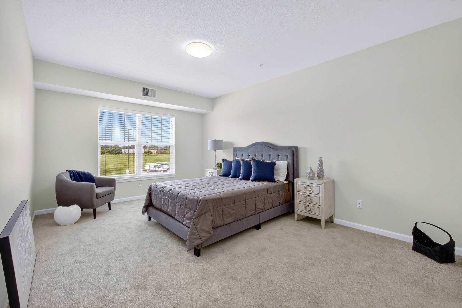 2592 Middle Road, Unit 202 Bettendorf, IA 52722 - Photo 24 of 50 a spacious bedroom with a bed and a window