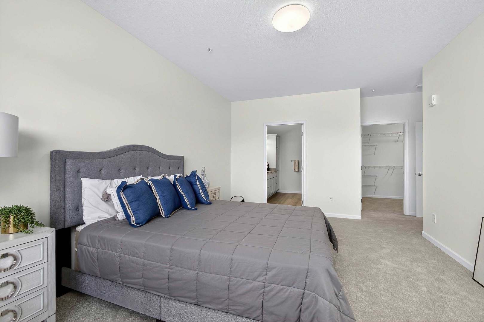 2592 Middle Road, Unit 202 Bettendorf, IA 52722 - Photo 25 of 50 a bedroom with a bed and a lamp