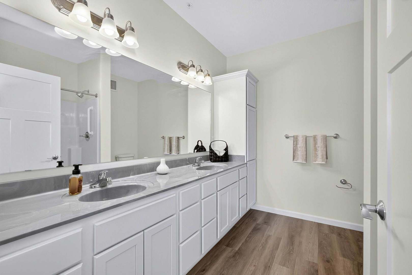 2592 Middle Road, Unit 202 Bettendorf, IA 52722 - Photo 27 of 50 a bathroom with a double vanity sink a mirror and a shower