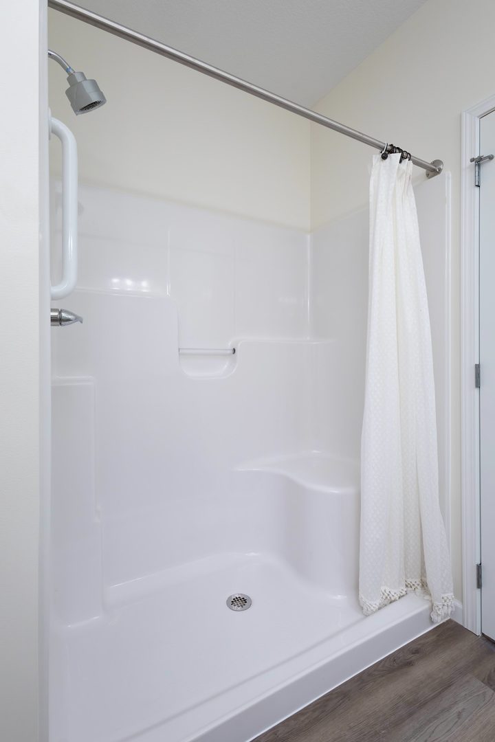 2592 Middle Road, Unit 202 Bettendorf, IA 52722 - Photo 28 of 50 a bathroom with a shower and a glass door