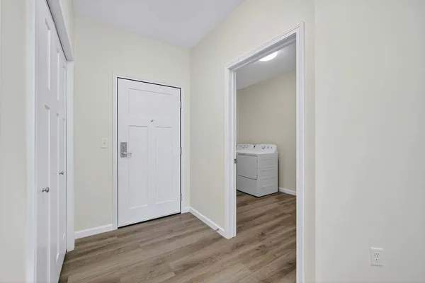 a view of a room with wooden floor