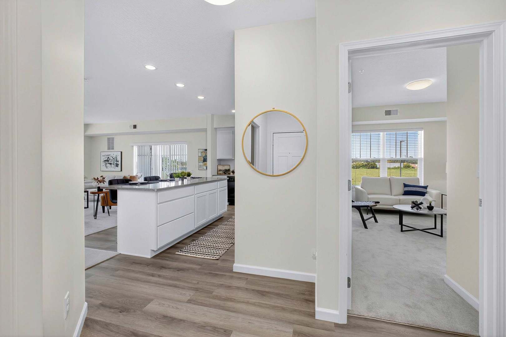 2592 Middle Road, Unit 202 Bettendorf, IA 52722 - Photo 5 of 50 a living room with furniture a mirror and a window