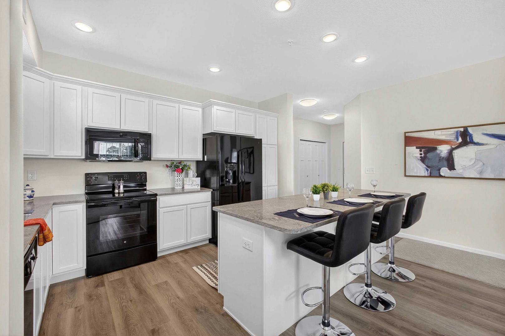 2592 Middle Road, Unit 202 Bettendorf, IA 52722 - Photo 10 of 50 a kitchen with stainless steel appliances kitchen island a table and chairs in it