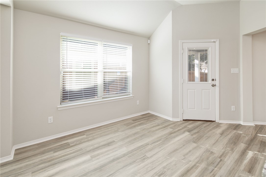 1203 High Street Navasota, TX 77868 - Photo 11 of 21 a view of an empty room with wooden floor and a window