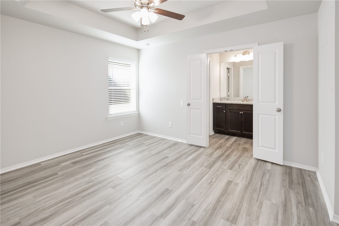 1203 High Street Navasota, TX 77868 - Photo 12 of 21 an empty room with wooden floor and windows