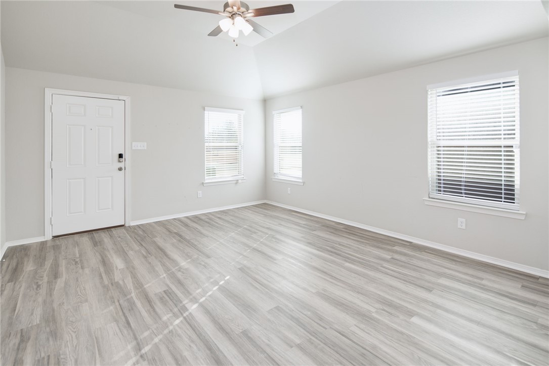 1203 High Street Navasota, TX 77868 - Photo 6 of 21 wooden floor in an empty room with a window
