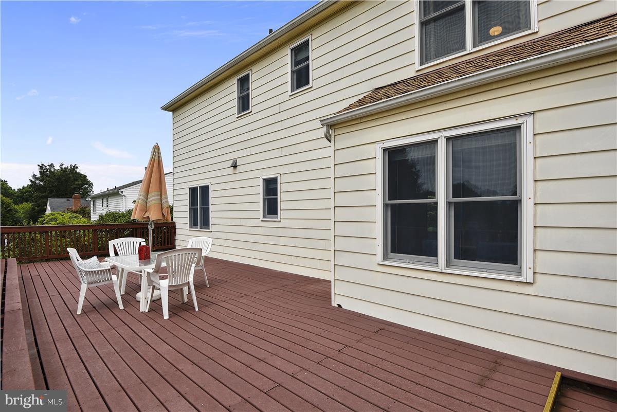 2313 Holly Spring Drive Silver Spring, MD 20905 - Photo 16 of 30 a deck with a table and chairs and wooden floor