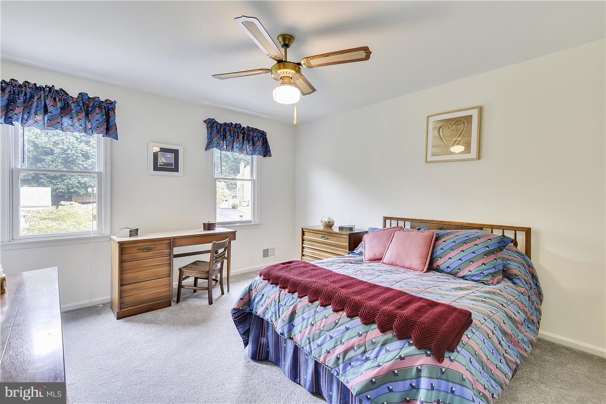 2313 Holly Spring Drive Silver Spring, MD 20905 - Photo 19 of 30 a bedroom with a bed and a table