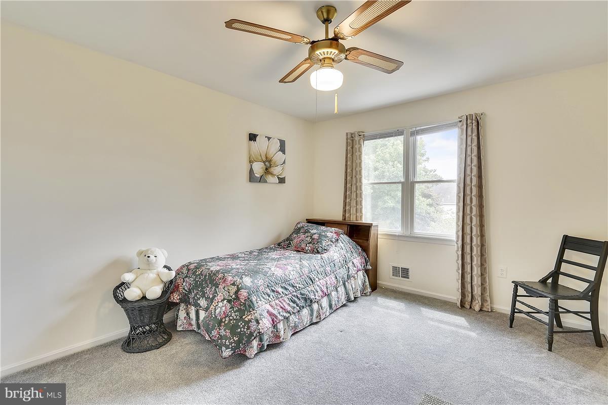 2313 Holly Spring Drive Silver Spring, MD 20905 - Photo 20 of 30 a bedroom with a bed and a window