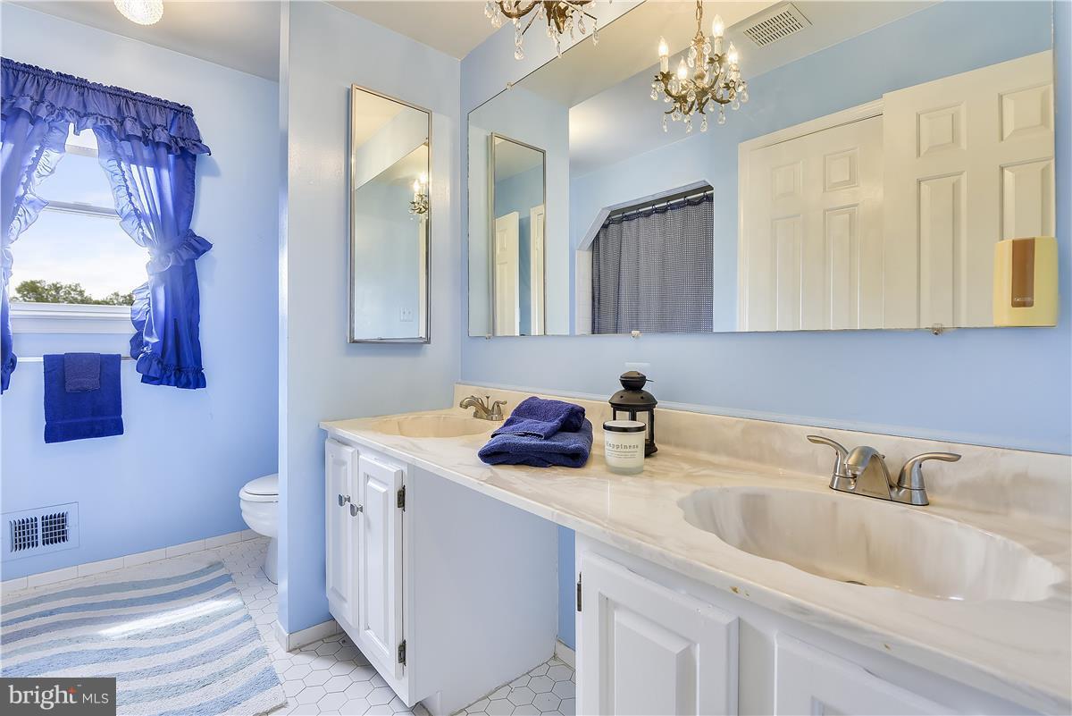 2313 Holly Spring Drive Silver Spring, MD 20905 - Photo 21 of 30 a bathroom with a sink a toilet and mirror