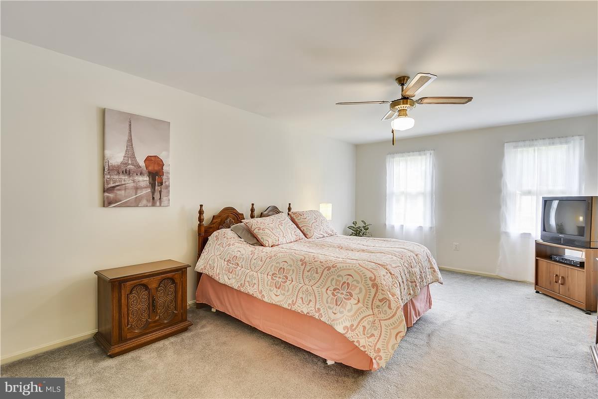 2313 Holly Spring Drive Silver Spring, MD 20905 - Photo 22 of 30 a bedroom with a bed a window and a chandelier