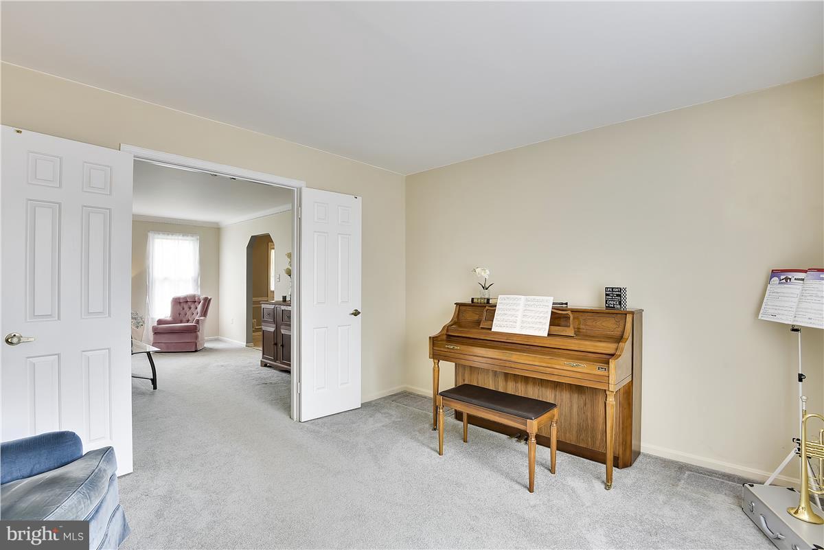2313 Holly Spring Drive Silver Spring, MD 20905 - Photo 7 of 30 a living room with furniture and a piano