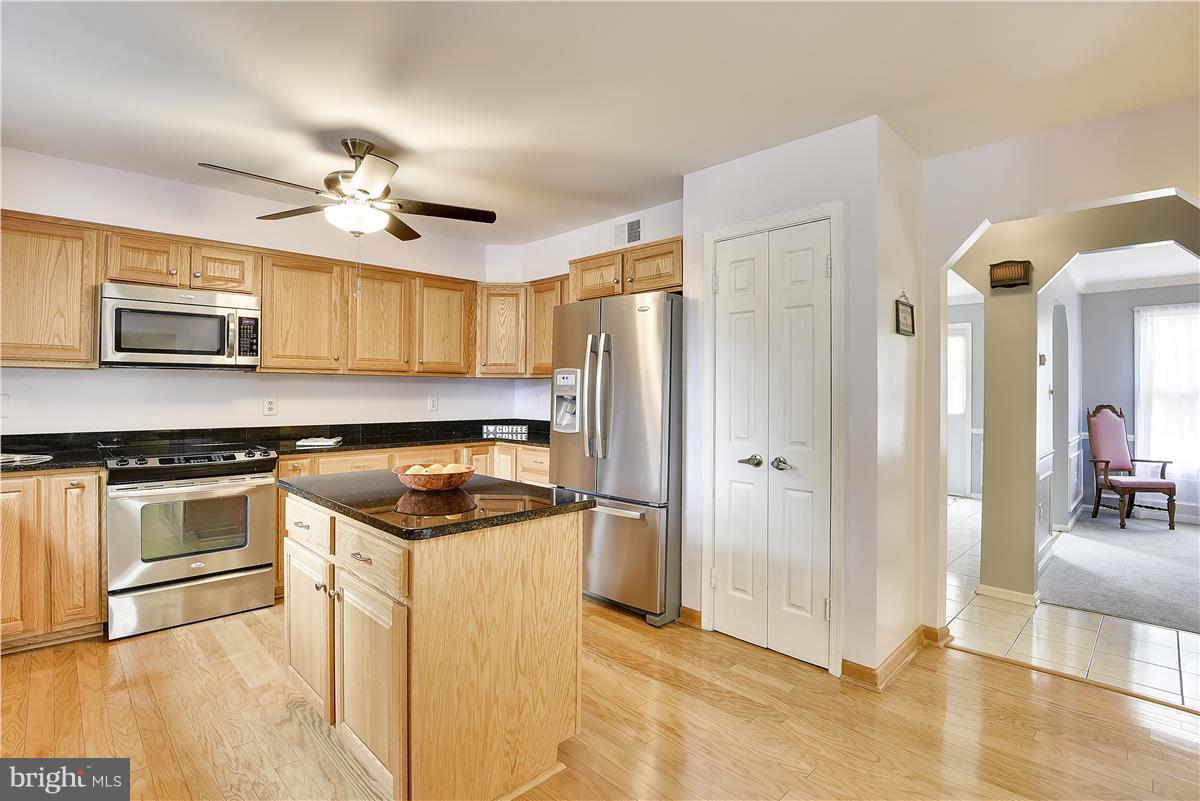 2313 Holly Spring Drive Silver Spring, MD 20905 - Photo 9 of 30 a kitchen with stainless steel appliances granite countertop a refrigerator and a stove top oven