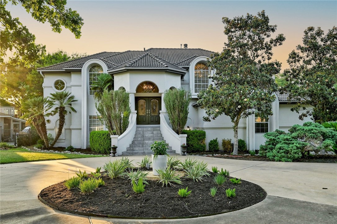 a front view of a house with garden