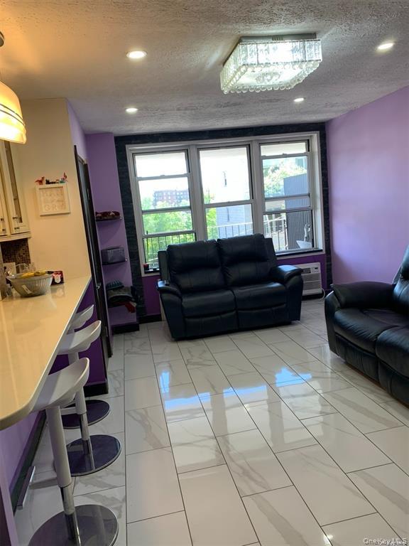 86-05 60th Road, Unit 3F Queens, NY 11373 - Photo 4 of 10 a living room with furniture and a window