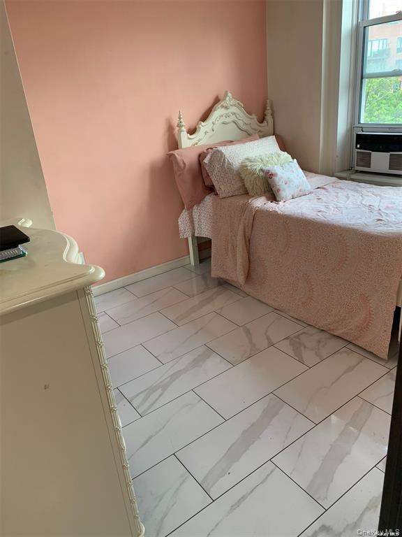 86-05 60th Road, Unit 3F Queens, NY 11373 - Photo 6 of 10 a bedroom with a bed and a window