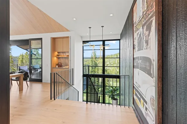 a view of a hallway with furniture and floor to ceiling window