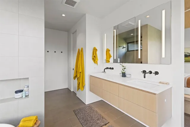 a bathroom with a tub sink and mirror