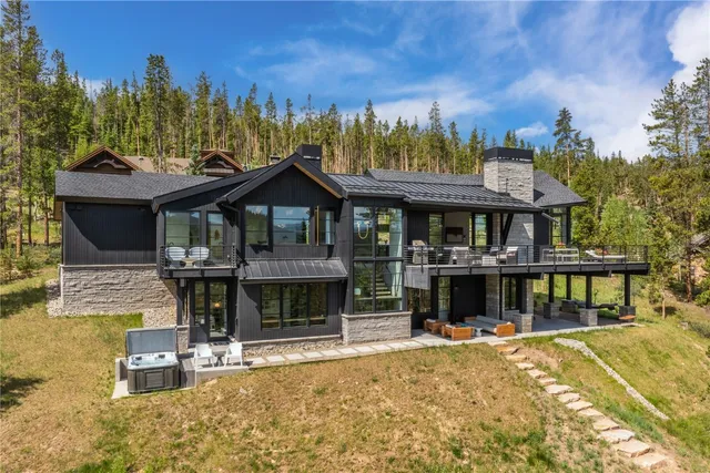 a view of a house with swimming pool and sitting area