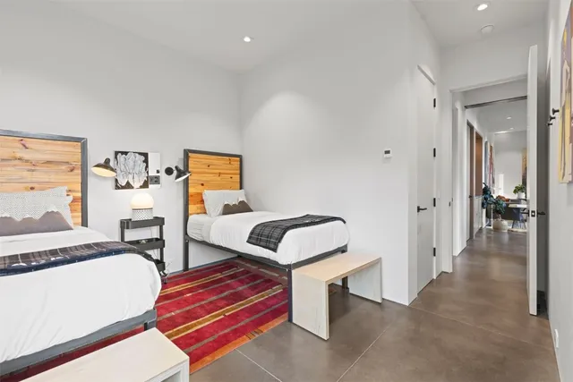 a bathroom with a tub a sink and a large window