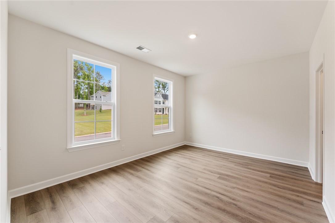 705 Weathered Oak Way Anderson, SC 29621 - Photo 37 of 47 This bright room features beautiful flooring and abundant natural light from multiple windows.