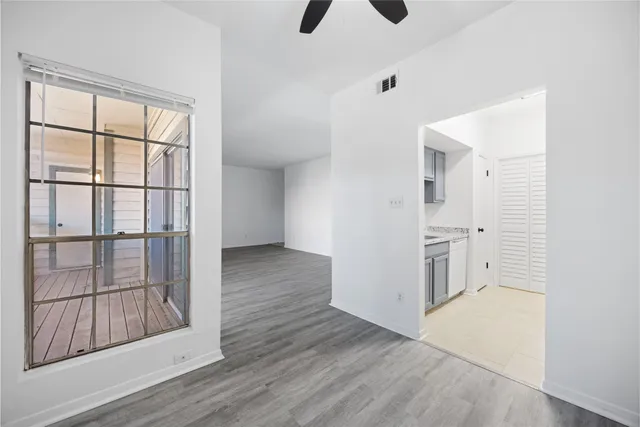 a view of empty room with wooden floor and cabinet
