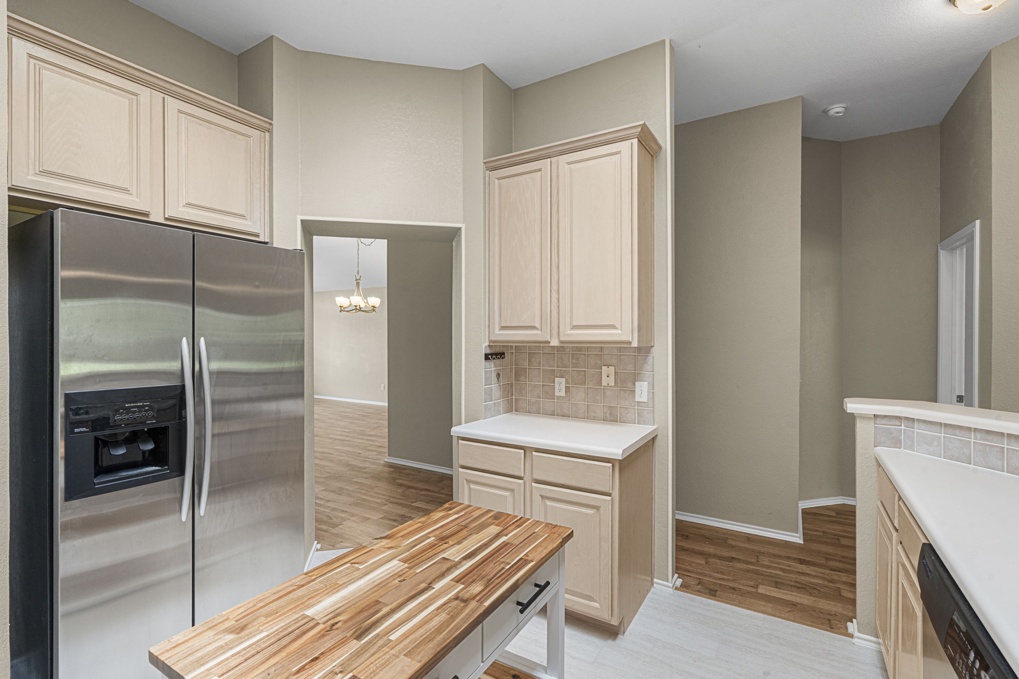 7172 Ridge Oak Road Austin, TX 78749 - Photo 21 of 40 A clean, functional kitchen featuring stainless steel appliances and light wood-look flooring.