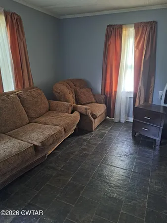 a living room with furniture and a window