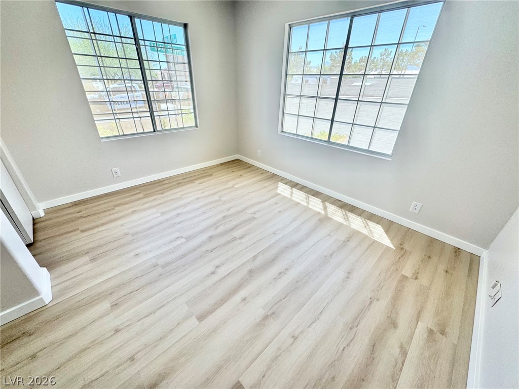 7340 Ridge Star Court Las Vegas, NV 89131 - Photo 9 of 22 Natural light streams into this pristine room with light wood-look flooring.