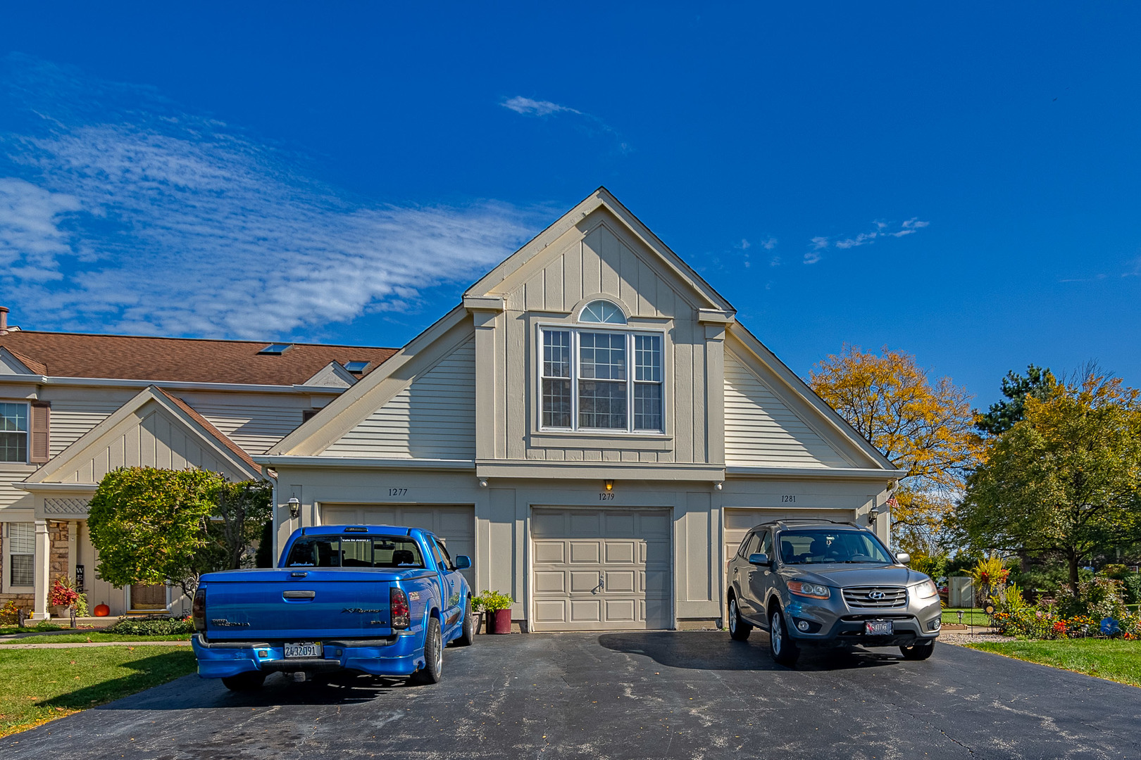 1279 Longacre Lane, Unit 1279 Wheeling, IL 60090 - Photo 1 of 14 a car parked in front of white house