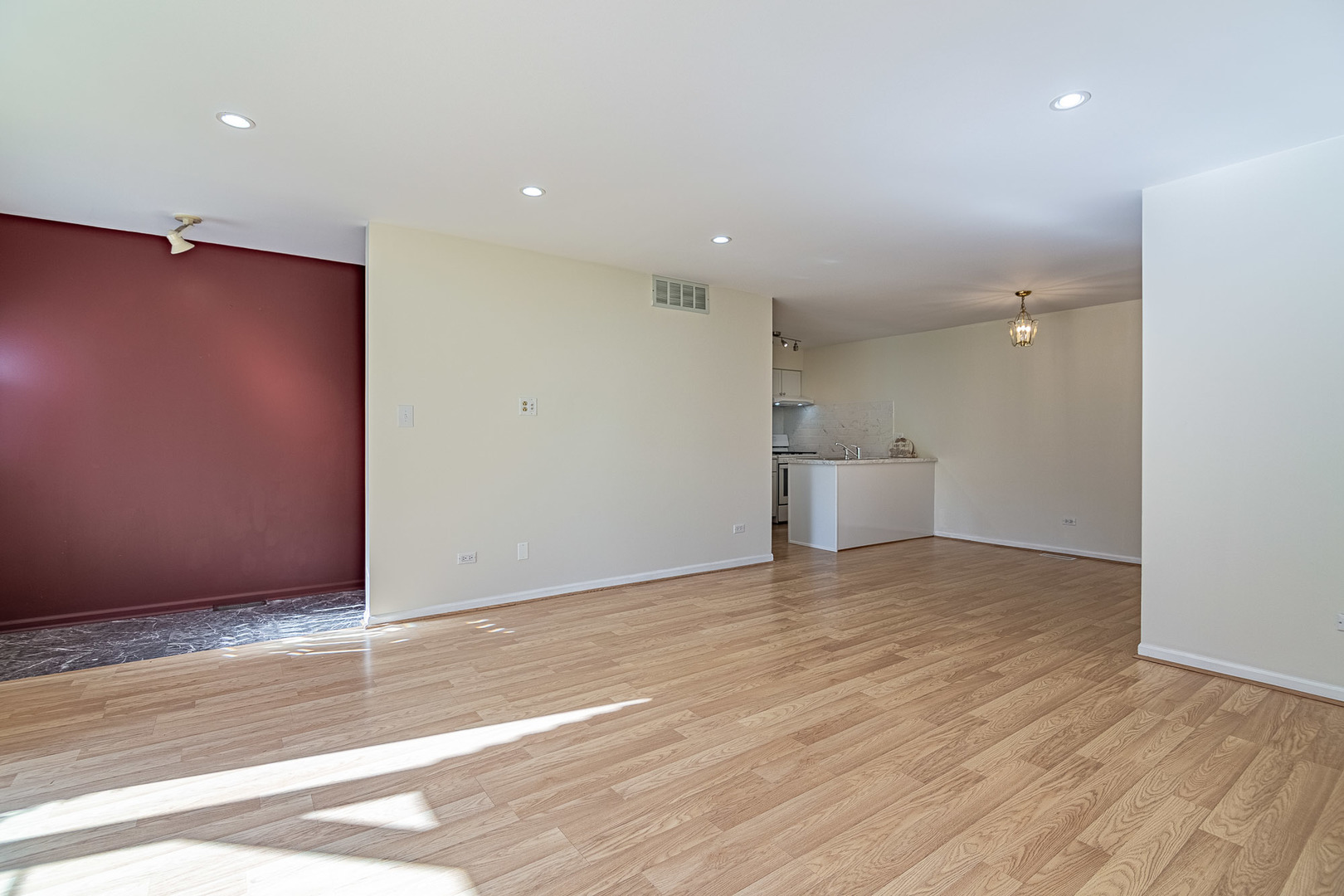1279 Longacre Lane, Unit 1279 Wheeling, IL 60090 - Photo 2 of 14 a view of empty room with wooden floor and kitchen