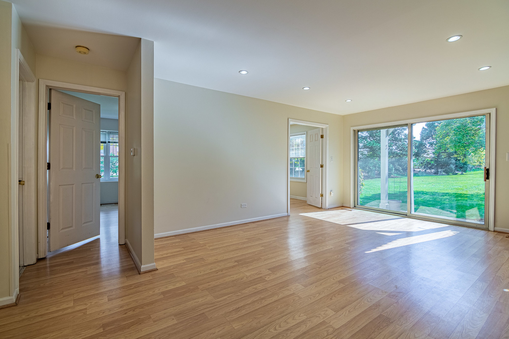1279 Longacre Lane, Unit 1279 Wheeling, IL 60090 - Photo 6 of 14 a view of an empty room with wooden floor and a window
