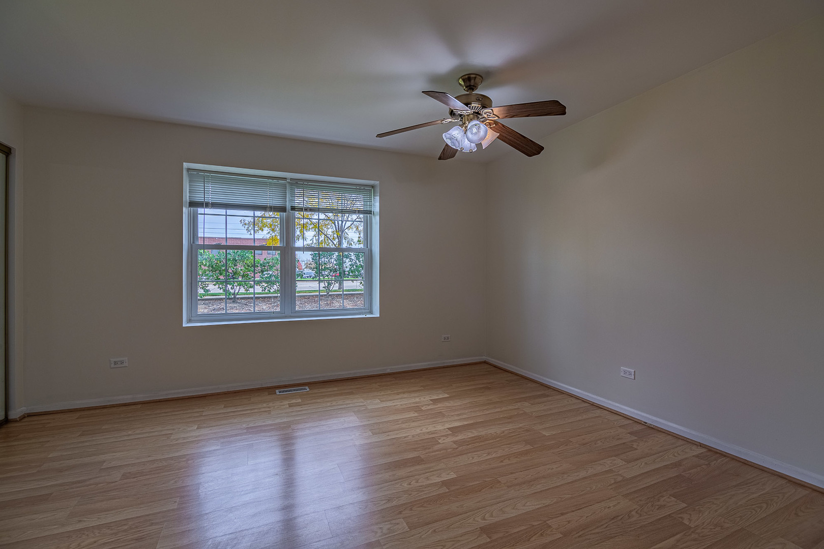 1279 Longacre Lane, Unit 1279 Wheeling, IL 60090 - Photo 9 of 14 a view of an empty room with wooden floor and a window