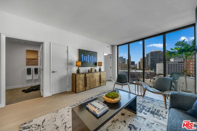 a living room with furniture and a floor to ceiling window