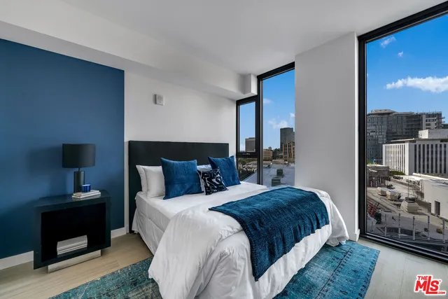 a bedroom with a bed and a tv on dresser