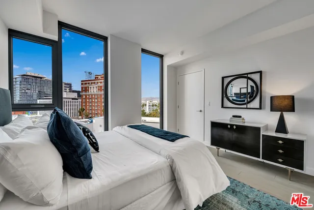 a bedroom with a bed and a television