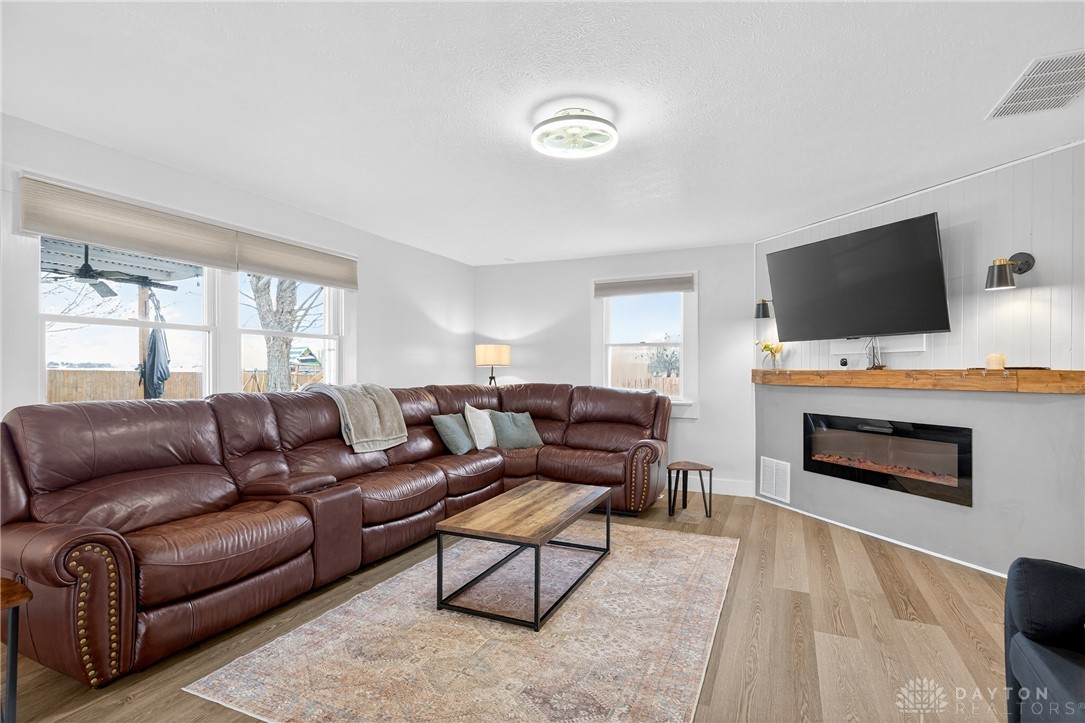 7888 Darke-Preble County Line Road Arcanum, OH 45304 - Photo 20 of 51 This inviting living room boasts an electric fireplace and durable hardwood flooring.