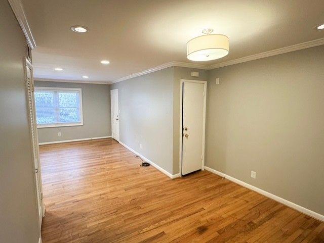 3510 Roswell Road Northwest, Unit J3 Atlanta, GA 30305 - Photo 12 of 17 an empty room with wooden floor and windows