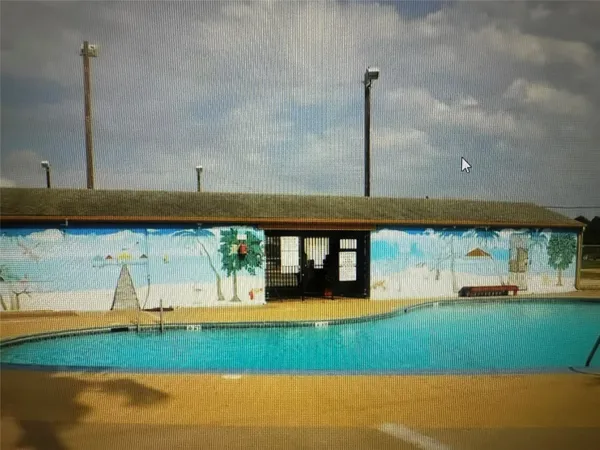 a view of a ocean with two houses in background