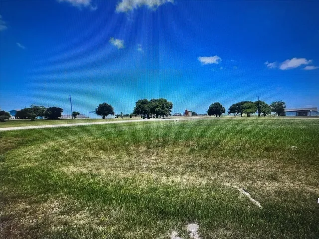 a view of a golf course with a big yard
