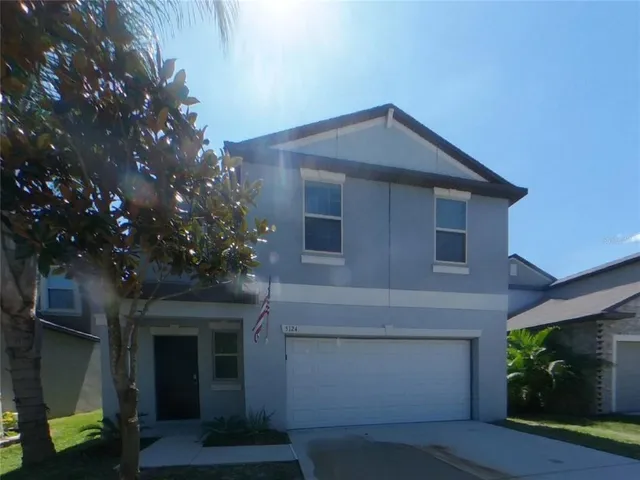 a front view of a house with plants