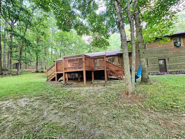 a view of a house with a backyard and a patio