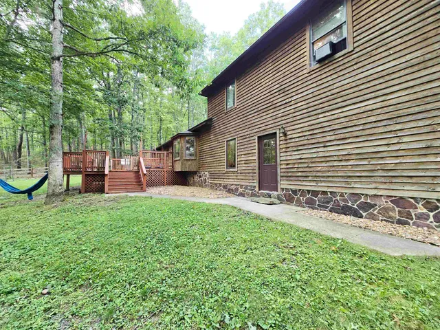 a backyard of a house with barbeque oven